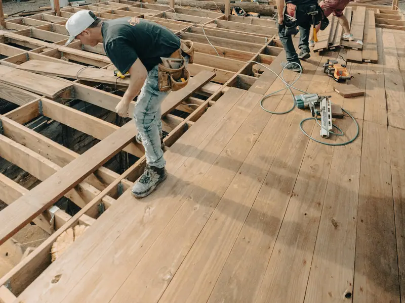 Crew framing a new deck with joists and beams